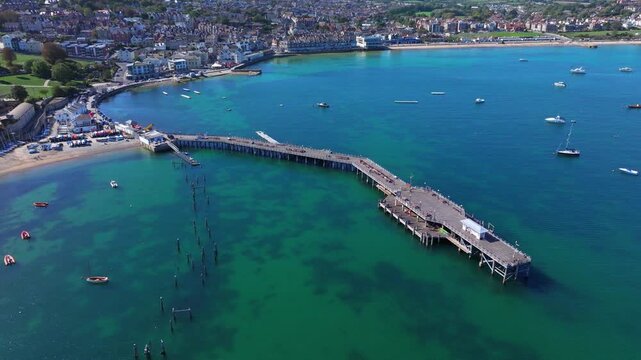 Aerial shot of Swanage Pier and seafront on a calm sunny day