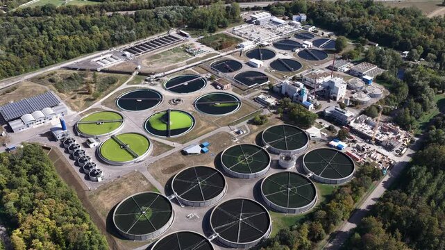 Aerial drone view of waste water treatment Karlsruhe, Germany, showing large-scale wastewater purification, clarifiers, treatment basins and municipal water infrastructure.