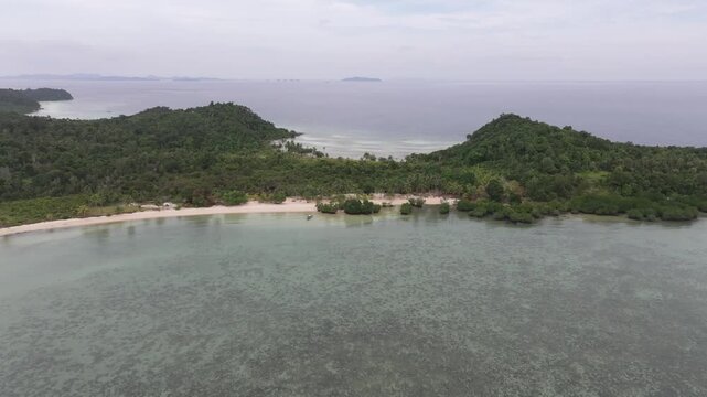 Aerial view of the lush tropical coastline and clear turquoise waters surrounding Batam Island in Batam, Riau Islands, Indonesia.