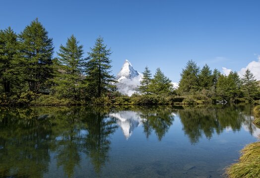 Snow-covered Matterhorn reflected in the lake, Lake Grindij, Zermatt, Wallis, Switzerland