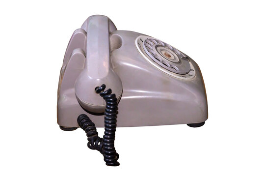 The old dial phone is dirty and scratched