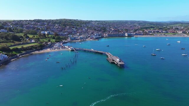 Aerial shot of Swanage Pier and seafront on a calm sunny day