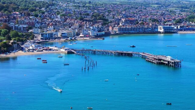 Aerial shot of Swanage Pier and seafront on a calm sunny day