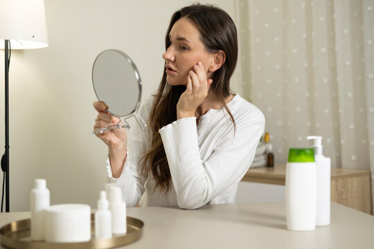 Woman filming a beauty blog about skincare products and cosmetics during a home beauty routine