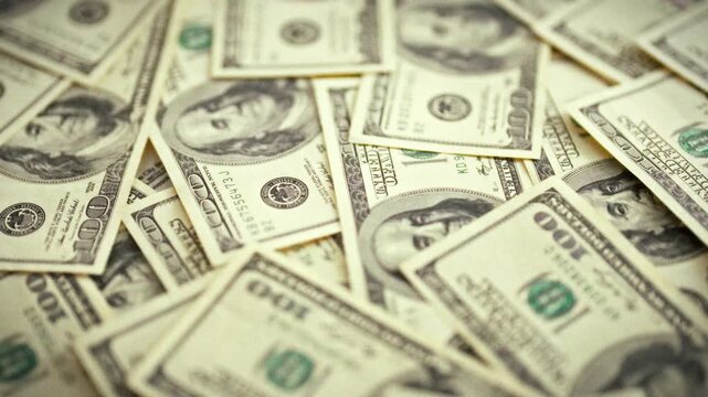 A stack of vintage dollar bills is arranged neatly on a table, serving as a backdrop for a finance concept. This cash layout represents expenses and budget, showcasing traditional paper money