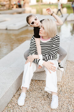 Mother hugging with her daughter outdoor in nature.