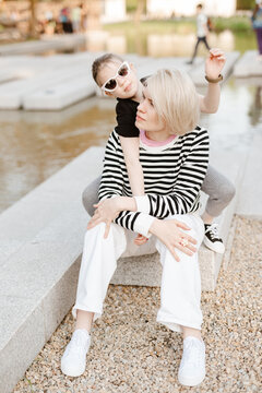 Mother hugging with her daughter outdoor in nature.