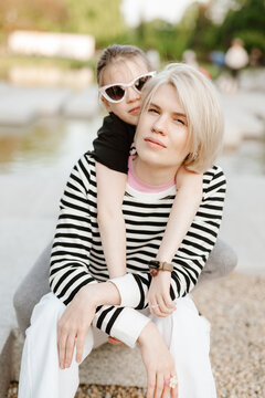 Mother hugging with her daughter outdoor in nature.