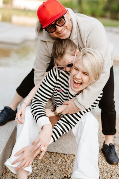 Young family with their daughter at park having fun together