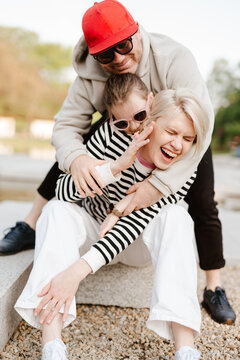 Young family with their daughter at park having fun together