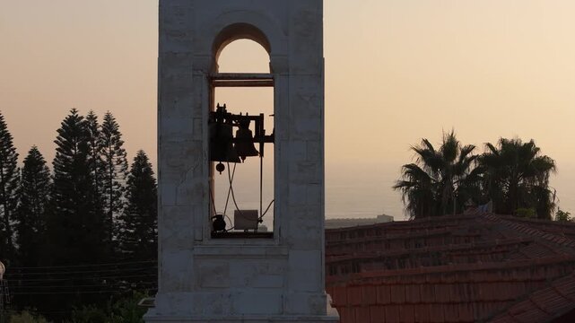 Aerial view of a historic bell tower at sunset with the Mediterranean Sea in the background in Nicosia, Nicosia, Cyprus.