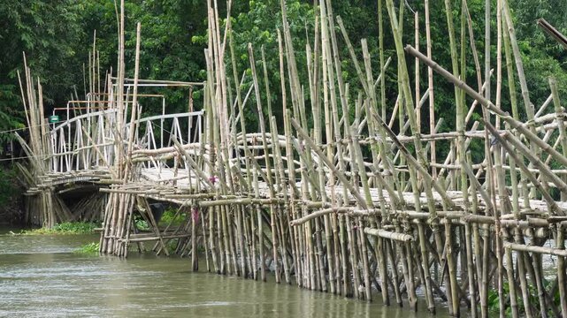 Traditional bamboo bridge crossing a river