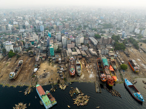 Aerial view of Sadarghat river port with numerous boats and ships docked along the Buriganga River, surrounded by dense urban buildings in Dhaka, Dhaka Division, Bangladesh.
