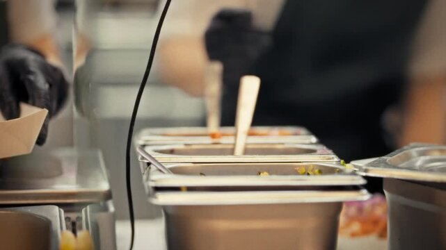 Close-up of a kiosk chef preparing vegetable toppings for takeaway customers. Concept of small businesses and street food vending as a business format