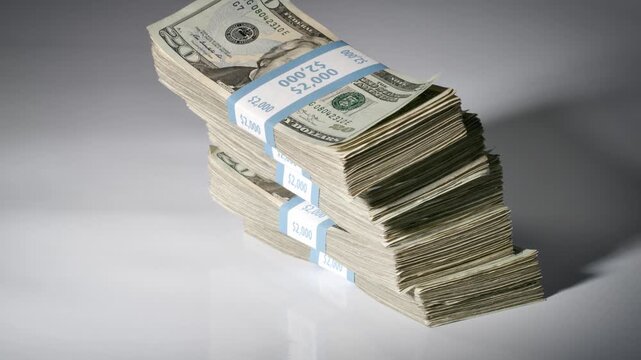 Stack of money falling and landing on a table. Slow Motion.