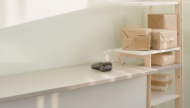 Retail collection counter with unmarked paper parcels on shelves