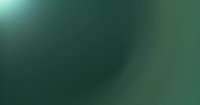 Soft cinematic lens flare glowing against a black background, with subtle green and blue optical highlights, ideal as a VFX overlay for films, transitions, music videos and motion graphics.