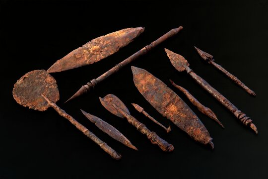 Collection of rusted ancient tools with viral infection patterns on black