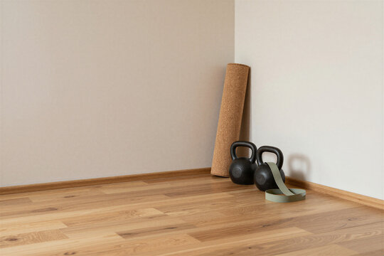 Home gym corner with kettlebells and a rolled mat