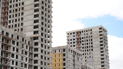 High rise residential buildings under construction showing concrete frames, unfinished apartments and large scale urban development project © belavinstock