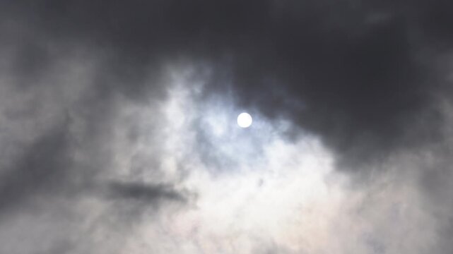 Dramatic sunlight bursting through dark storm clouds