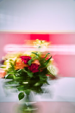Motion Blur Flower Bouquet with Roses on Abstract Pink Background