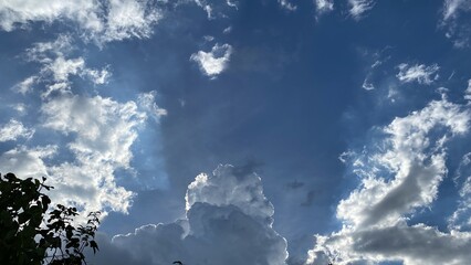 Movement of Beautiful dark rain storm clouds reveals the sun, thunderstorm in dramatic sky, with lens flare. Climate cloudscape scenic. Weather tropical summer squall. © praditkhorn