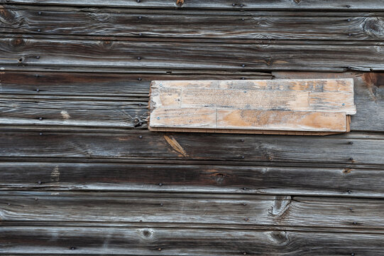 Rustic wooden wall with a blank plaque