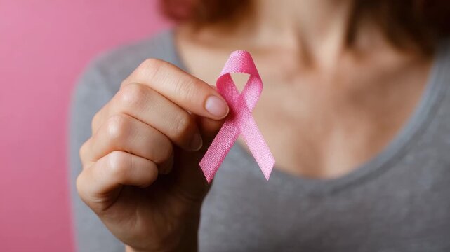female hand hold pink ribbon breast cancer health care concept animation