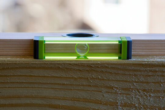 Spirit level on a timber beam with the bubble centred, accuracy and alignment concept