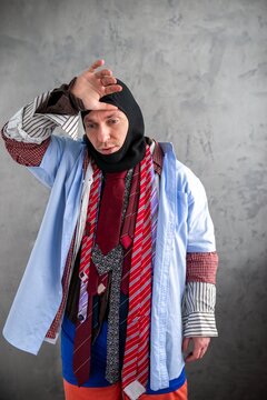 Overheated man in a balaclava wearing multiple layered shirts
