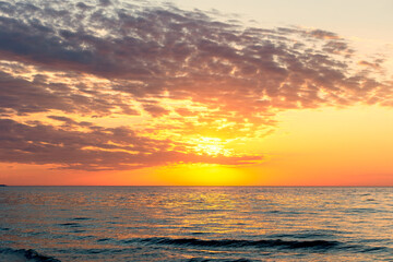 Fototapeta premium Colorful sunset over calm ocean horizon scene