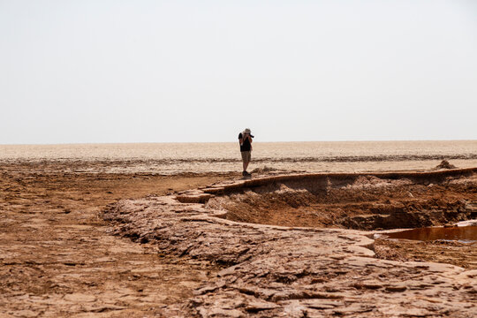 Photographer at the edge of a salt flat, Dallol, Ethiopia