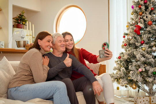 Family Moment Selfie During Holiday Celebration in Cozy Living Room