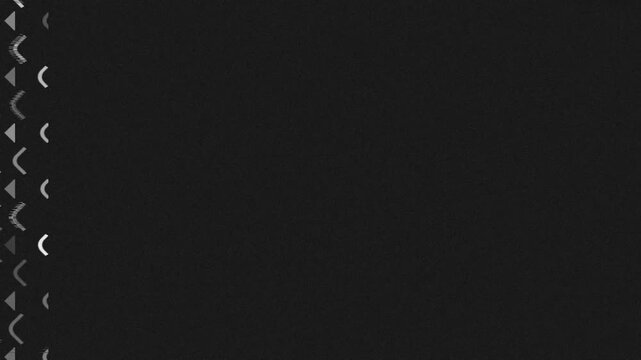 Vertical strip of repeating gray and black chevron arrows on a dark background