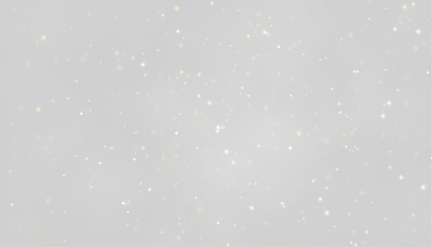A dense field of small glowing particles is scattered across a dark background. The particles vary in size and color, predominantly white and warm amber hues.