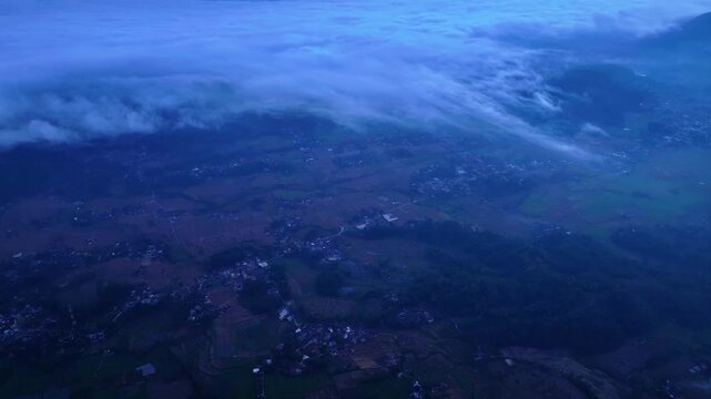 Aerial drone view of rural landscape with rolling clouds at twilight