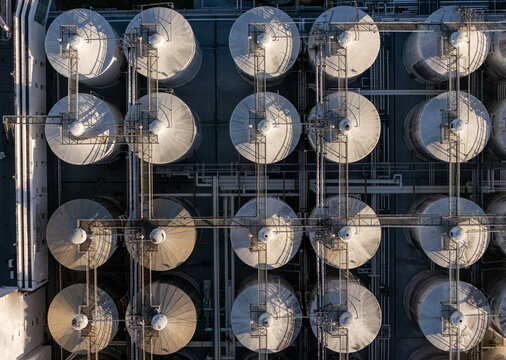 Aerial view of a beer industrial complex with large metal fermentation tanks and connecting pipes in Santo Domingo, Dominican Republic.