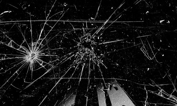Cracked glass texture with radial impact pattern on black background broken screen effect