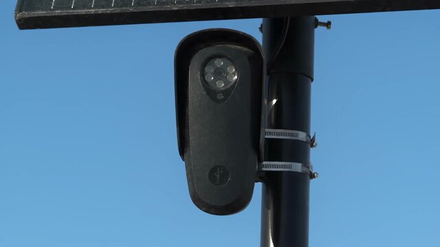 Close Up of Black License Plate Camera Against Blue Sky