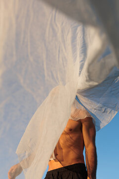Topless Man In Transparent Tulle Curtain