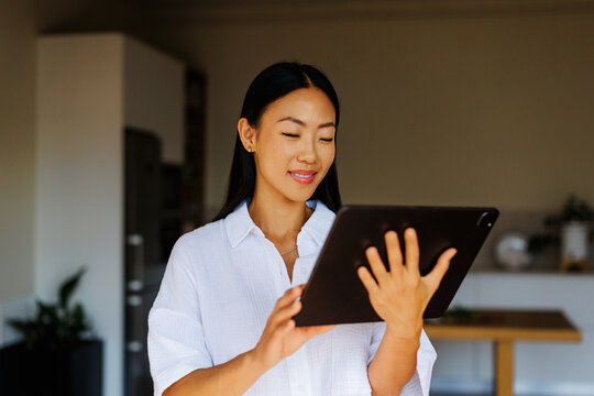 Woman connecting with digital data using tablet device