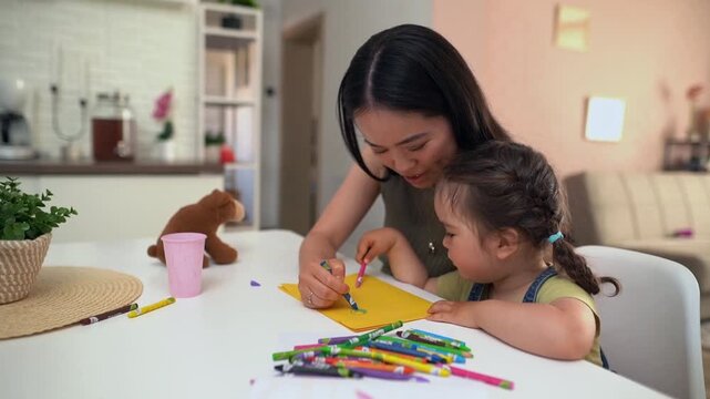 Japanese mother and daughter drawing together at home