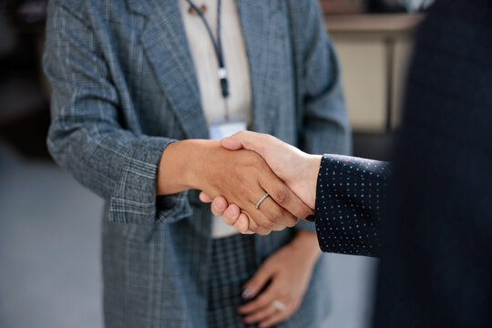 Business handshake between two people in suits