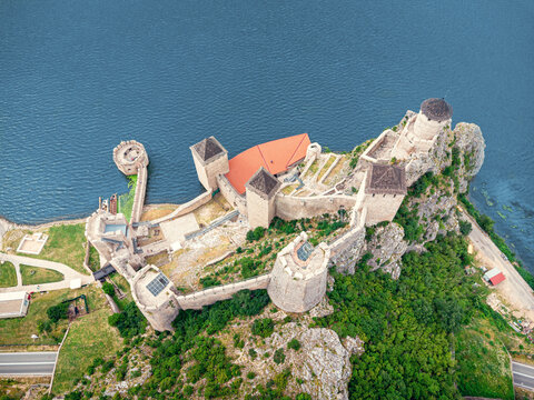 bird's-eye drone perspective reveals the full stone layout of Golubac Fortress jutting into the Danube