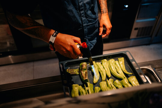 Chef Cooking Peppers in Kitchen During Evening