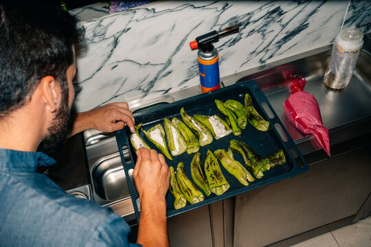 Cooking Chiles on a Tray in a Kitchen During the Evening