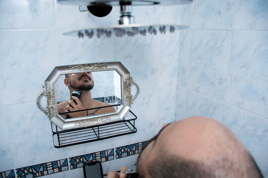 Man Shaving in Bathroom With Vintage Mirror