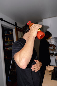 UGC Surprised man holding tomato sauce and shielding from camera flash