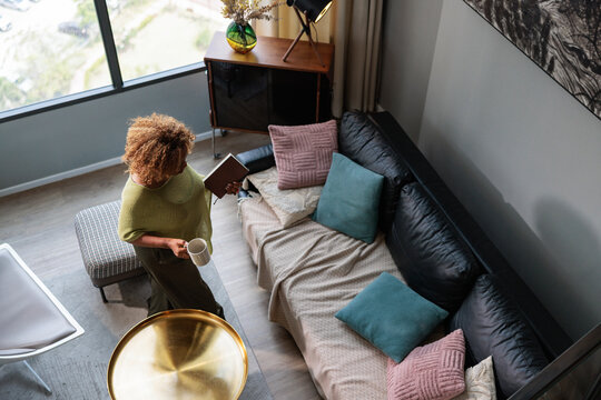 A woman enjoys a peaceful moment in her modern home